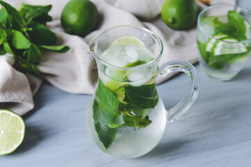 Jug of fresh mojito on table