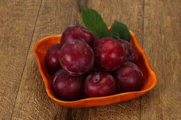 Plum heap in the wooden basket