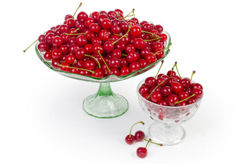 Fresh sour cherries in two different glass fruits bowls