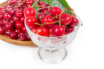 Sweet cherries in glass cup against the sour cherries closeup