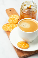 apricot jam in a jar and coffee for breakfast.