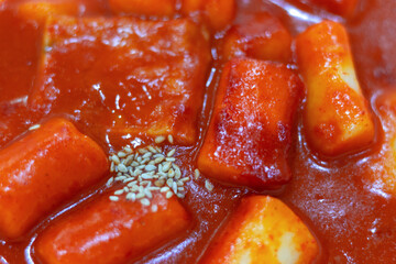 Spicy korean dish topokki of rice dumplings close-up top view.