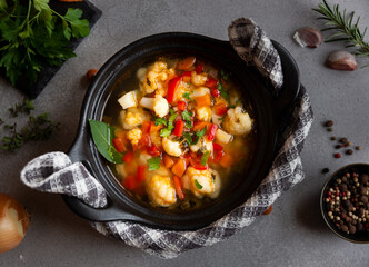 Vegetable soup with cauliflower, laurel and other vegetables in cooking pot