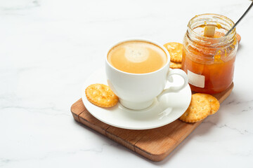 jam with crackers and coffee on a white background.