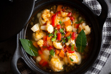 Vegetable soup with cauliflower, laurel and other vegetables in cooking pot