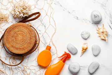 Composition with bag and sunscreen cream on white background