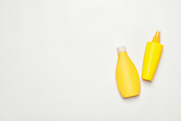 Bottles of sunscreen on white background