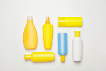Bottles of sunscreen on white background