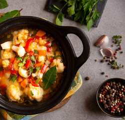 Vegetable soup with cauliflower, laurel and other vegetables in cooking pot