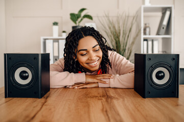 Cute woman between two audio speakers, music