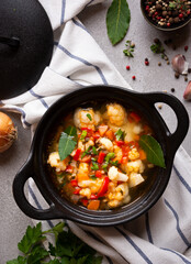 Vegetable soup with cauliflower, laurel and other vegetables in cooking pot