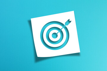 Note paper with target sign on blue background