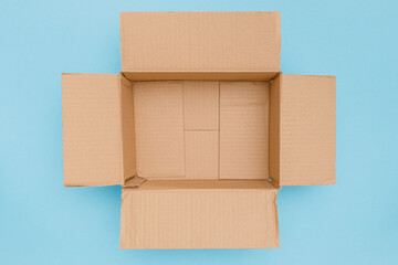 blank open cardboard box in top view isolated on blue background