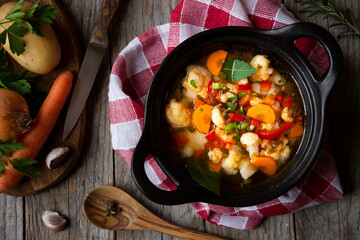 Vegetable soup with cauliflower, laurel and other vegetables in cooking pot