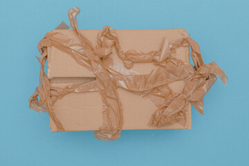 wrinkled parcel tape failed to packed up a brown cardboard box