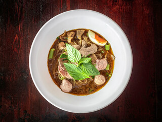 thai oriental noodle, nooddle in blood seasoning soup with meat ball and pork