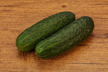Green fresh cucumbers over background