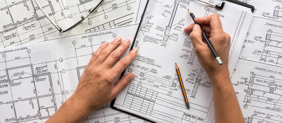 architect design working drawing sketch plans blueprints and making architectural construction...