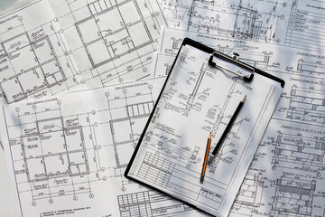 architect design working drawing sketch plans blueprints and making architectural construction model in architect studio,flat lay
