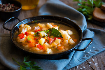 Vegetable soup with cauliflower, laurel and other vegetables