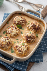 Baked meatballs with cabbage and rice with sour cream sauce