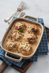 Baked meatballs with cabbage and rice with sour cream sauce