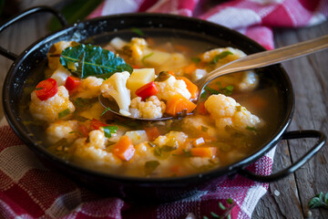 Vegetable soup with cauliflower, laurel and other vegetables