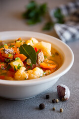 Vegetable soup with cauliflower, laurel and other vegetables