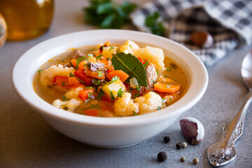 Vegetable soup with cauliflower, laurel and other vegetables