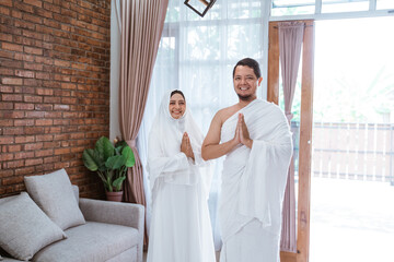 muslim couple wearing white Ihram traditional clothes hajj and umrah