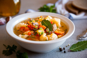 Vegetable soup with cauliflower, laurel and other vegetables