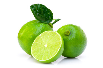 Closeup two whole fresh organic lime fruits with green leaf and cut in half slice isolated on white...