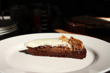 A piece of homemade delicious brownie with cream and dried fruit dates and cantaloupe