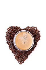 Fresh tasty espresso cup of hot coffee on heart-shaped coffee beans