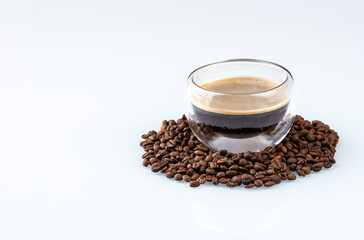 Cup of hot coffee on coffee beans background