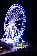 Ferris wheel lumining at night