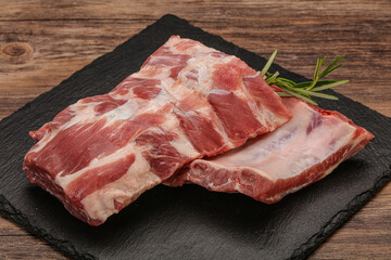 Raw pork ribs served rosemary