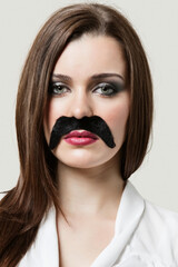 Woman wearing fake moustache