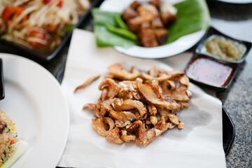 Close up Delicious Thai food pork rind with many food on background.