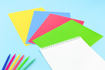 color paper, scissors, pencils paint and various school stationery on blue yellow background. Flat lay with copy space for back to school or education and craft concept 