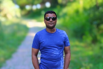 portrait of smart young south asian man wearing sunglasses 