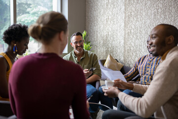 Smiling businesspeople sitting together in an office lounge