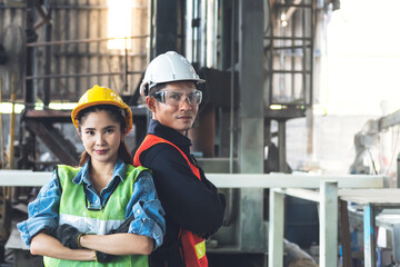 Fototapeta na wymiar Portrait images of engineers Asian man and woman are standing in workplace which is and industrial factory, to engineering and technician concept.