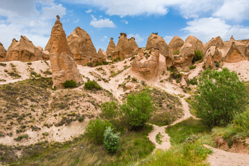 Fototapeta na wymiar A path leads through the unique landscape and fairy chimney rock formations in Devrent Valley, known also as Imagination Valley, near Goreme in Nevsehir Province, Cappadocia Turkey