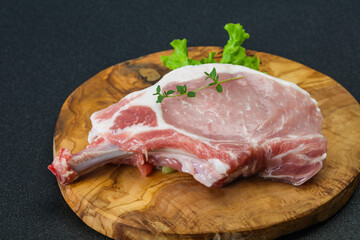 Raw pork bone steak over wooden