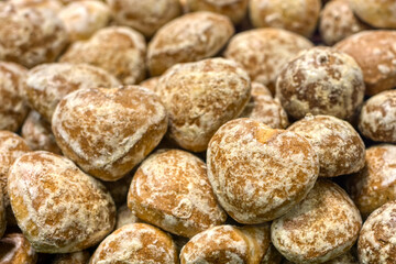 A lot of glazed gingerbread cookies, a bunch lies on a shop window.