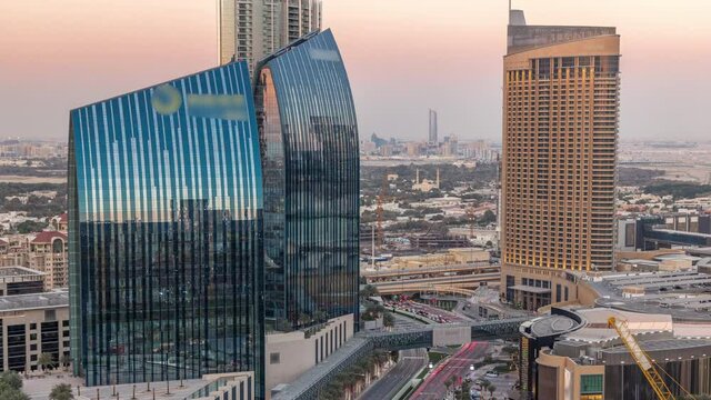 Dubai downtown street during sunset with busy traffic and skyscrapers around timelapse. Modern road and urban buildings with mall aerial view. Sheikh Mohammed bin Rashid Blvd