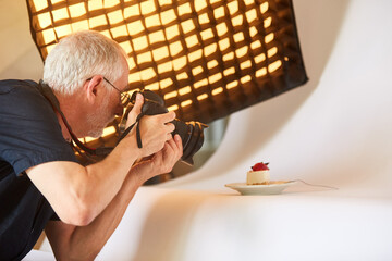 Photographer with camera photographs food