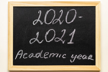 School chalkboard in wooden frame.  And text 2020-2021 academic year. Back to school  concept.