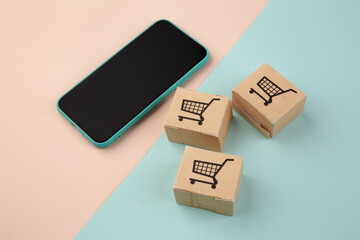Fototapeta premium Online shopping and ecommerce via internet concept : boxes next a smartphone.